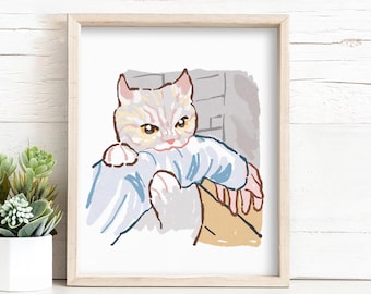 Può includere: Una stampa artistica incorniciata con un'illustrazione ad acquerello di un gatto. Il gatto ha gli occhi gialli ed è grigio chiaro con strisce gialle. Indossa un indumento blu ed è tenuto in un cestino beige. L'opera d'arte è in una cornice di legno chiaro.