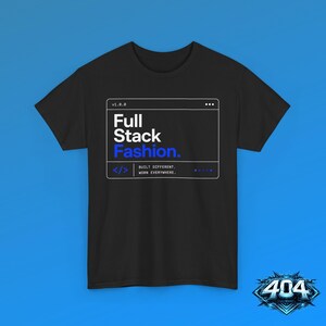 May include: A black short-sleeve t-shirt featuring a white and blue graphic box on the chest. The text reads v1.0.0, Full Stack Fashion., and < /> BUILT DIFFERENT. WORN EVERYWHERE. with a series of five blue dots in the bottom right corner.
