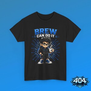 May include: A black t-shirt featuring a graphic of a cartoon character wearing glasses and a hoodie, holding a steaming mug. The text above the character reads "BREW CAN DO IT" in blue letters, set against a blue radial line background pattern.