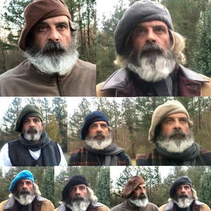 May include: A collection of berets in various colors, including brown, gray, blue, and black. The berets are worn by a person with a long, gray beard and mustache. The person is wearing different outfits, including jackets and scarves.