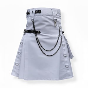 May include: A light gray kilt with black metal chain and ring accents. The kilt features a black leather belt, silver-tone metal hardware, and a pleated design. The kilt has a modern, edgy style.