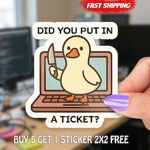 May include: A sticker featuring a cartoon duck holding a knife, emerging from a laptop screen. The text "DID YOU PUT IN A TICKET?" is displayed. The sticker has a white border and a red "FAST SHIPPING" banner.