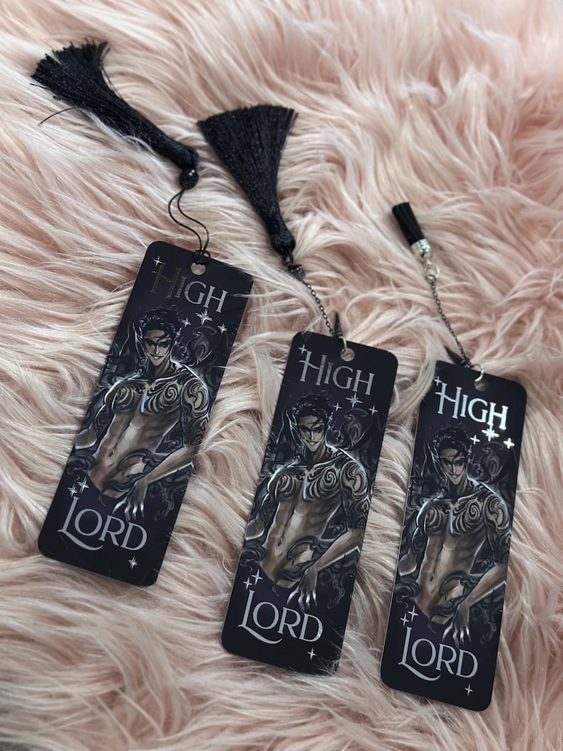 May include: Three black bookmarks with a silver chain and tassel. Each bookmark features a black and white illustration of a man with tattoos and the text "HIGH LORD".
