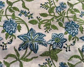 May include: Floral fabric featuring a repeating pattern of blue and green flowers and leaves on a light background. The design includes large, stylized blooms and delicate sprigs, creating a botanical theme.