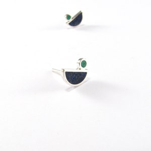 May include: A pair of silver earrings with a blue and green stone design. The earrings are shaped like a half-circle with a small green stone on top.