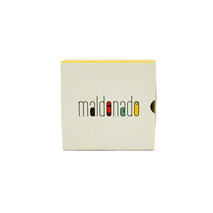 May include: A white box with a yellow top and the word "maldonado" in black letters with colored accents.