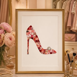 May include: Framed artwork featuring a high-heeled shoe silhouette. The shoe is filled with a patchwork of red and white floral patterns. A decorative button adorns the toe. The artwork is set against a white background within a gold frame.
