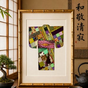 May include: Framed artwork featuring a colorful patchwork kimono design. The kimono is composed of various fabric squares in shades of green, purple, and pink. The artwork is framed in a gold bamboo-style frame, creating a decorative piece.