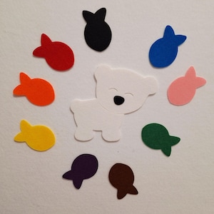 May include: A white felt polar bear with a black nose and eyes is surrounded by colourful felt fish in red, orange, yellow, green, blue, pink, purple, brown, and black. The image is on a white background.
