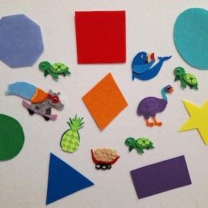 May include: A collection of colorful felt shapes and animal figures. Includes a red square, blue triangle, green circle, and a yellow star. Also features a blue seal, purple ostrich, green turtles, and a rhino on a skateboard.