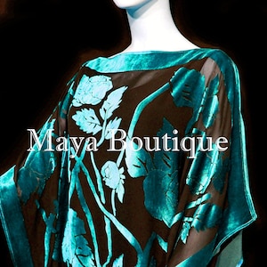 May include: A teal blue and black sheer shawl with a floral pattern. The shawl has a wide, teal blue border. The text "Maya Boutique" is visible on the shawl.
