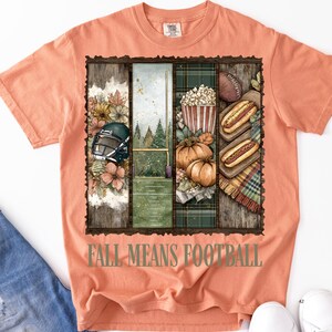 May include: Peach-colored t-shirt with a rectangular graphic featuring football-themed imagery. The graphic includes a football helmet, a football field, pumpkins, popcorn, hot dogs, and the text "FALL MEANS FOOTBALL".