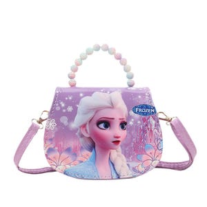 May include: A purple purse featuring a portrait of Elsa from the movie Frozen. The purse has a beaded handle and a detachable shoulder strap. The design includes snowflakes and floral accents.