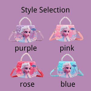 May include: Four colorful purses, each featuring a princess design and the word "Frozen". The purses come in purple, pink, rose, and blue. Each purse has a beaded handle and a shoulder strap. The text "Style Selection" is at the top.