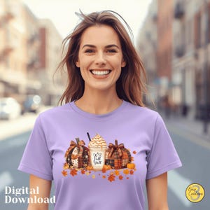 May include: A lilac t-shirt with a seasonal graphic. The design features two pumpkins, a coffee drink, and autumn leaves. The text "It's fall y'all" is printed on the coffee cup. The words "Digital Download" are printed on the bottom left.