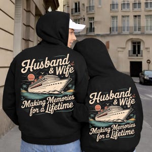 May include: Black hoodies with the text "Husband & Wife" above a cruise ship graphic. The phrase "Making Memories for a Lifetime" is below the graphic. The hoodies are worn by a couple.