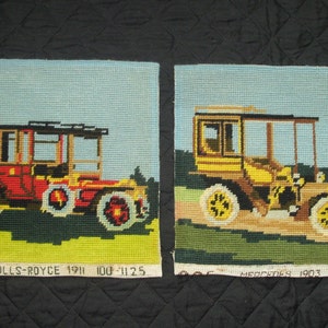May include: Two vintage needlepoint pictures of antique cars. The first picture shows a red Rolls-Royce with the text "COE ROLLS-ROYCE 1911 100-1125". The second picture shows a yellow Mercedes with the text "MERCEDES 1903 100-1146".