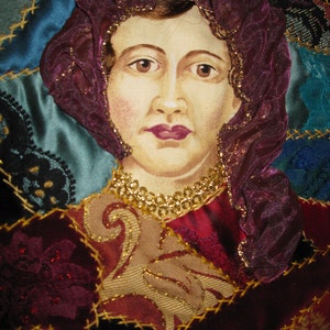 May include: A portrait of a woman with dark hair, wearing a purple and gold head covering, set against a background of colorful fabric.
