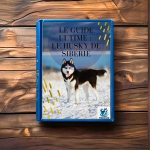 Puede incluir: Un libro azul titulado "LE GUIDE ULTIME: LE HUSKY DE SIBÉRIE" presenta un Husky Siberiano en la portada. El perro tiene pelaje blanco y negro y ojos azules, de pie en la nieve. El libro está sobre una superficie de madera.