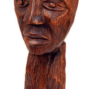 May include: A wooden sculpture of a person with a carved face and a textured, brown finish.