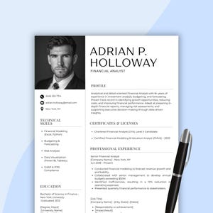 May include: A black and white resume template for a Financial Analyst, featuring a headshot, contact information, skills, education, and professional experience. A black pen rests on the right side of the resume.