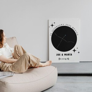 May include: A white canvas print with a black circle and star constellation design. The print includes the text "24 January 2035 Mexico" and "JOE & MAR&Iacute;A You are my sky". The print is displayed indoors.