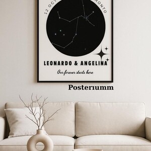 May include: A framed black and white print featuring a constellation map. The print includes the date "12 October 2025 Toronto" and the names "Leonardo & Angelina" with the text "Our forever starts here". The word "Posteriumm" is printed at the bottom.