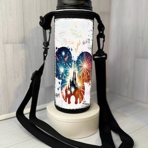 May include: White water bottle with a black lid and strap. The bottle features a colourful design of fireworks and a castle silhouette within a Mickey Mouse head shape. The design is accented with colourful signatures. The bottle is on a white stand.