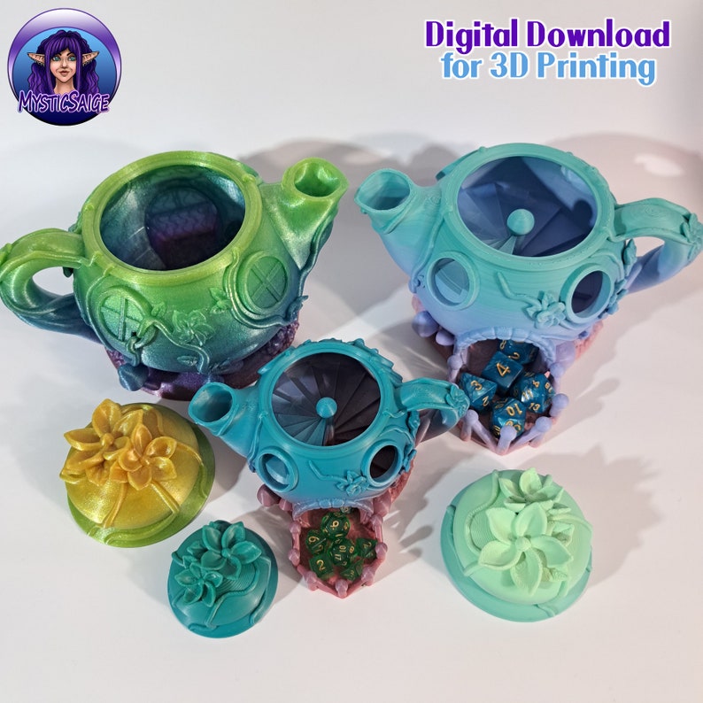 May include: Three teal and green ceramic teapots with lids and floral designs. Each teapot has a hole in the top and a base with a floral design. The teapots are on a white surface with dice inside.