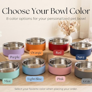 May include: Image shows eight stainless steel pet bowls with colored exteriors: purple, orange, red, navy, mint, light blue, pink, and gray. Text reads "Choose Your Bowl Color" and "8 color options for your personalized pet bowl."