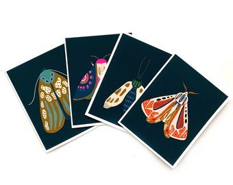 May include: Set of four illustrated cards featuring colourful moths on a dark blue background. Each card features a different moth with intricate patterns and details.