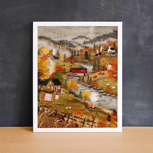 May include: A framed landscape painting depicting a rural autumn scene with a winding river, a red covered bridge, scattered houses, and sheep grazing in fields. The artwork features vibrant orange and yellow trees, a campfire, and a clothesline.