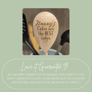 May include: Wooden spoon with the text "Nanny's Cakes are the BEST cakes" engraved on the spoon. The spoon is surrounded by other kitchen utensils. The image is set against a light green background.