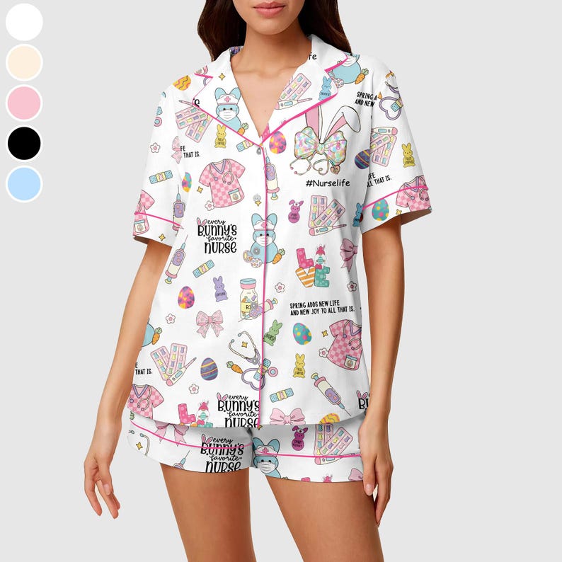 May include: White pajama set with a colorful bunny and medical-themed print. The short-sleeved top and shorts feature pink trim and the text "Every bunny's favorite nurse" and "#Nurselife".