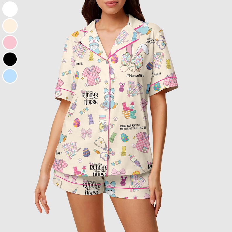 May include: A two-piece pajama set featuring a cream-colored top and shorts. The set is adorned with a repeating pattern of Easter-themed medical illustrations, bunnies, and the text "Every bunny's favorite nurse." The trim is pink.