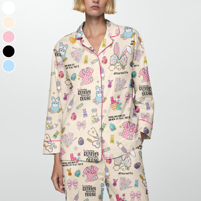 May include: Beige pajama set with a repeating pattern of Easter-themed medical illustrations, bunnies, and text. The set includes a button-down top with pink trim and matching pants. Text includes "Every Bunny's Favorite Nurse" and "#NurseLife."