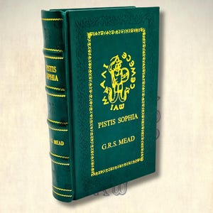 May include: A dark green hardcover book, "Pistis Sophia" by G.R.S. Mead, with gold lettering and decorative borders. The spine displays the title and author's name in gold. The book's cover features an illustration.
