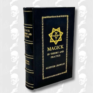 May include: A hardcover book titled "Magick in Theory and Practice" by Aleister Crowley. The book has a black cover with gold lettering and a gold decorative border. The spine also has gold lettering. The book features a yellow star symbol.