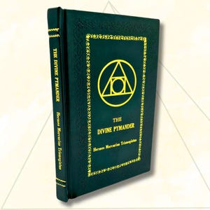 May include: A dark green hardcover book titled "The Divine Pymander" by Hermes Mercurius Trismegistus. The cover features gold lettering and a gold geometric symbol. The spine also has the title in gold.