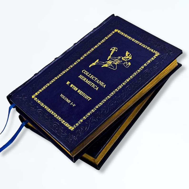 May include: A stack of dark blue hardback books with gold lettering and detailing. The covers display the title "Collectanea Hermetica" and the author's name, W. Wynn Westcott. A blue ribbon bookmark is visible.
