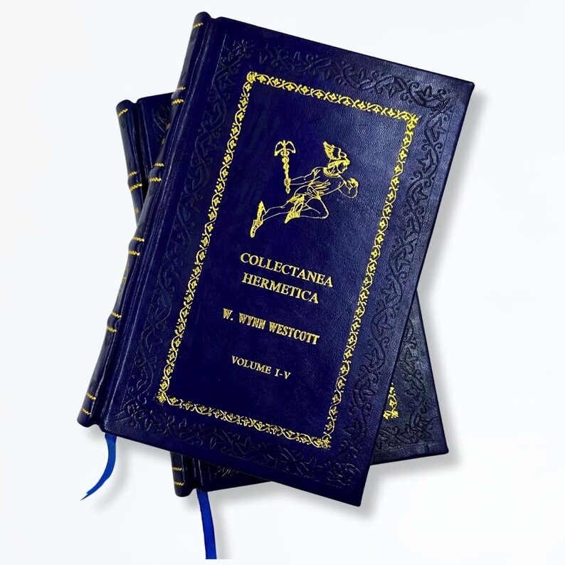 May include: A stack of dark blue hardcover books with gold lettering and decorative borders. The book title "Collectanea Hermetica" is visible, along with the author's name, W. Wynn Westcott, and "Volume I-V". Blue ribbon bookmarks are visible.