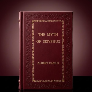 May include: A hardback book titled "The Myth of Sisyphus" by Albert Camus. The book has a deep red cover with gold embossed decorative borders and lettering. The spine is also red.