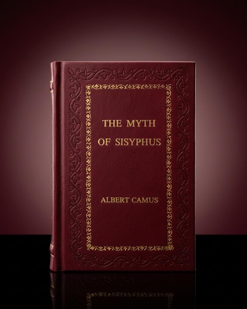 May include: A hardback book titled "The Myth of Sisyphus" by Albert Camus. The book has a deep red cover with gold embossed decorative borders and lettering. The spine is also red.