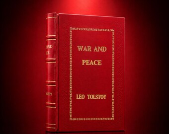 May include: A hardcover book titled War and Peace by Leo Tolstoy with a deep red cover. The front features gold embossed lettering and a decorative gold border. The spine also displays gold lettering and horizontal raised bands in red.