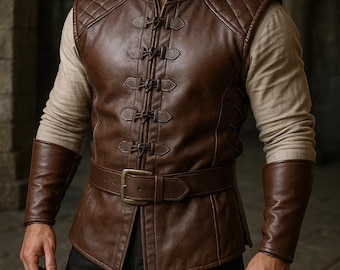 May include: A brown leather vest with a quilted design on the shoulders and a belted waist. The vest has a series of decorative clasps down the front. The sleeves are long and brown, and the shirt underneath is a light tan color. The overall style is reminiscent of historical or fantasy attire.