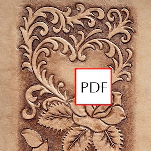 May include: A light tan leather surface featuring a deeply embossed design of a rose and swirling floral vines arranged in a heart shape. A white square box with a red border containing the black text PDF is centered over the embossed rose.