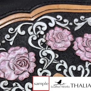May include: Close-up of a black leather item with embossed pink roses and silver scrollwork. The design includes a tan border and the word "sample" in a red box. The image also shows the text "Leather Works THALIA".