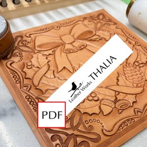 May include: A light brown leather craft featuring a Christmas bow and holly design. The image includes the text "THALIA" and "PDF" in a red box. The Leather Works logo is also visible.