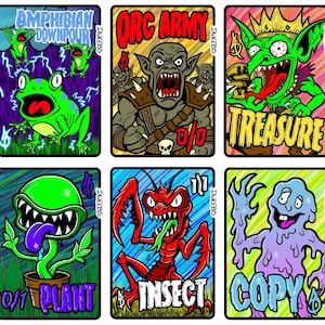 May include: A collection of ten rectangular trading cards featuring colorful cartoon illustrations of creatures and objects, including a keyboard, frogs, an orc, a goblin, a bird, a snake, a plant, an insect, a blob, and a saproling.