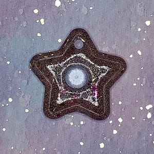 May include: A white ceramic mug with a black handle and the text "But First, Coffee" in a black, bold font. The mug is on a white surface. The mug is approximately 4 inches tall.